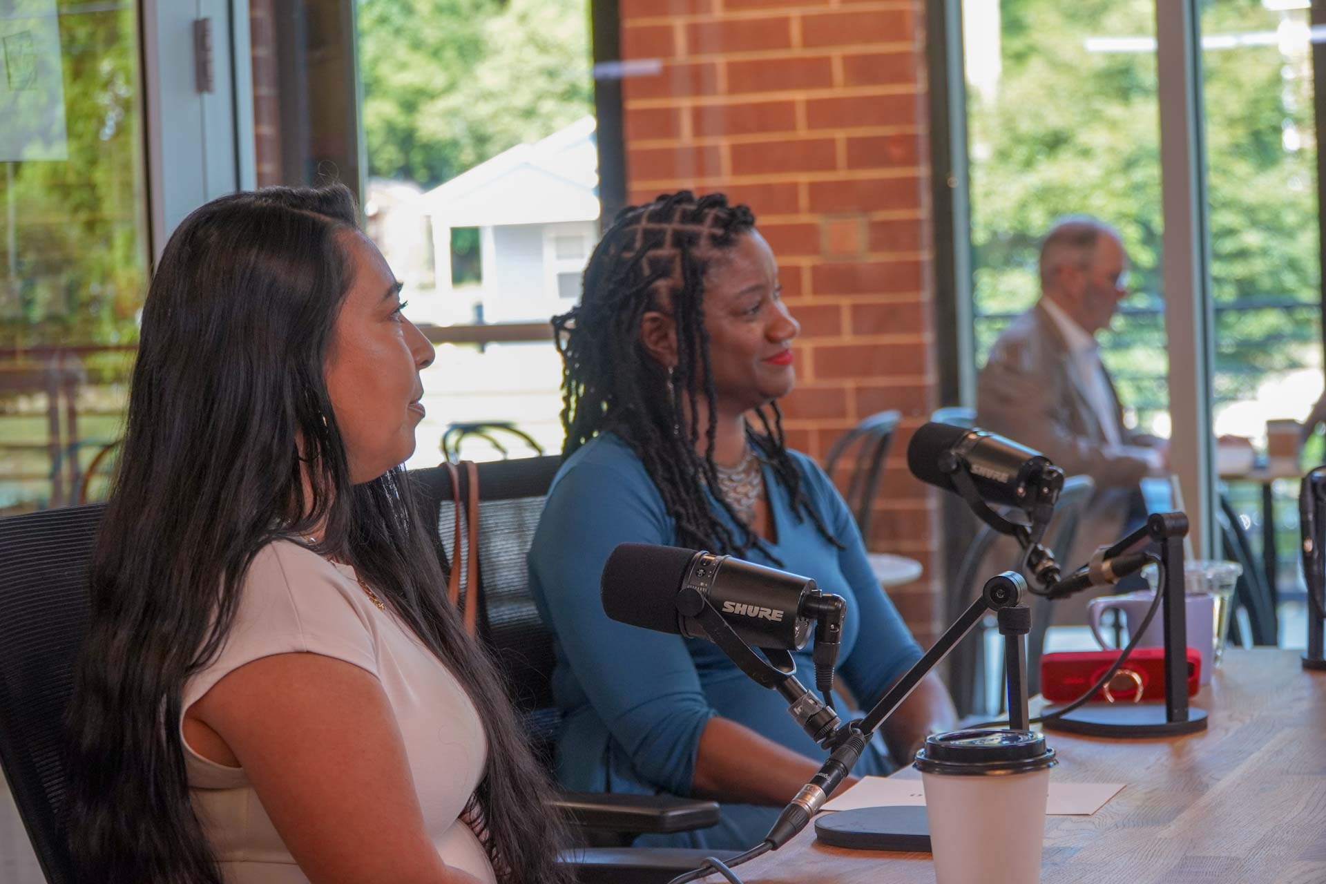 Podcast Titans films a roundtable podcast in a Charlotte coffee shop